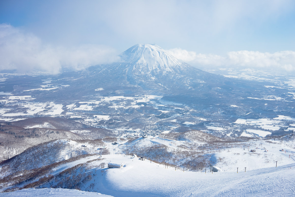 Snowboarders queuing up to ride King Quad chairlift in Niseko.