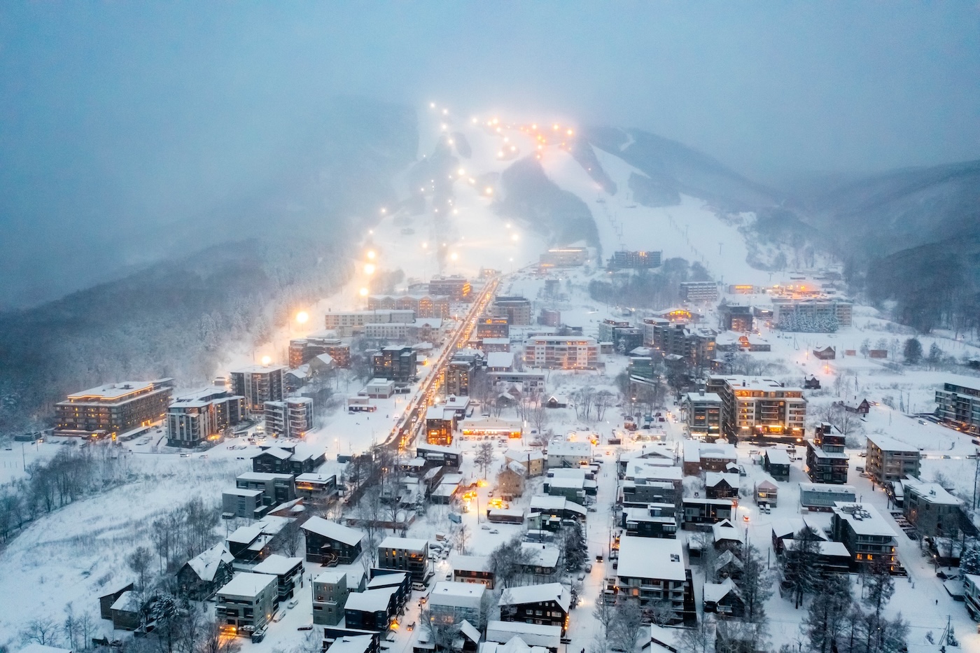 niseko-resort-upgrades-1 An aerial view of Hirafu village covered in snow and a layer of fog
