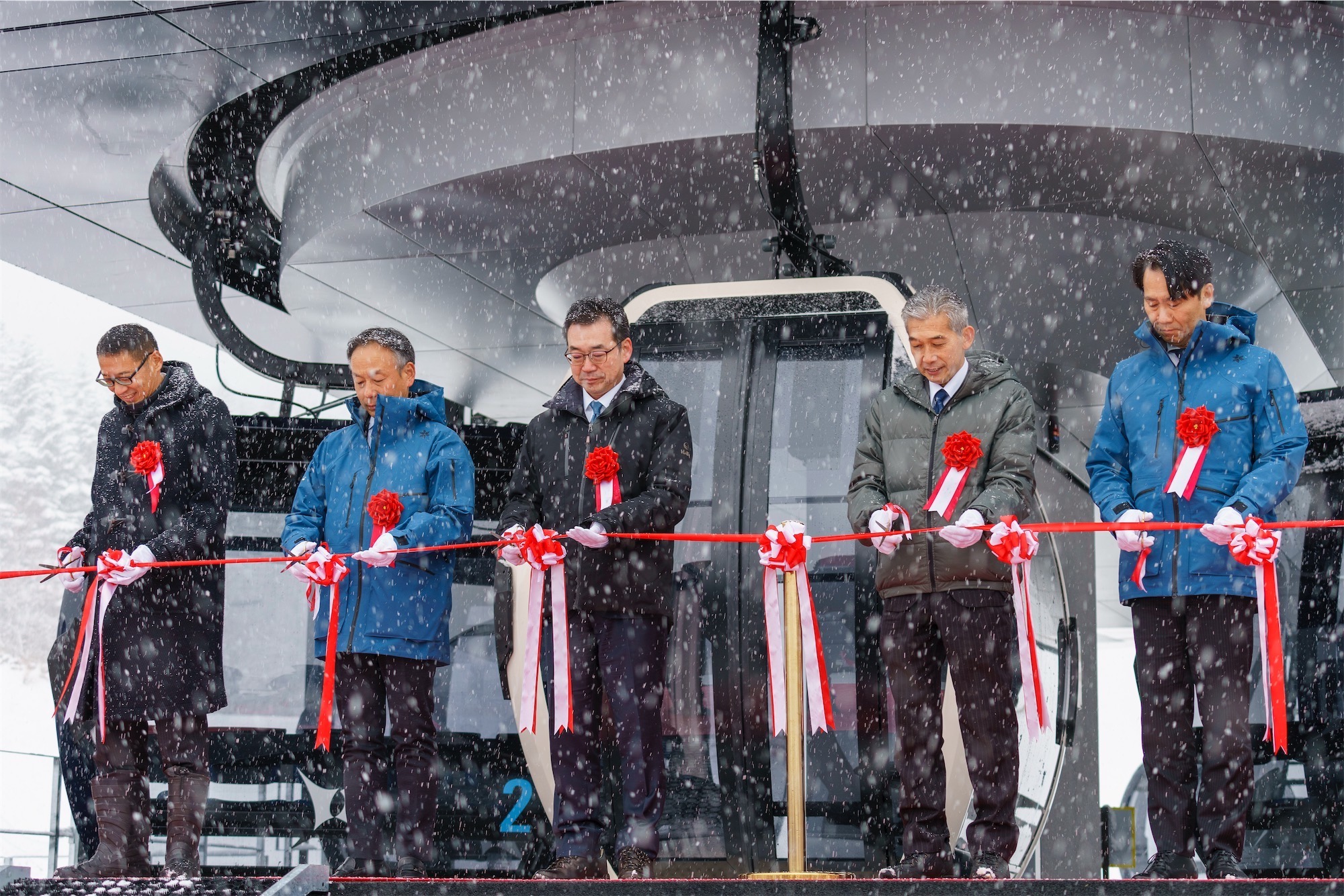 niseko-resort-upgrades-4 Five men cutting a red ribbon in front of a brand new gondola, marking the opening of one of the latest Niseko resort upgrades