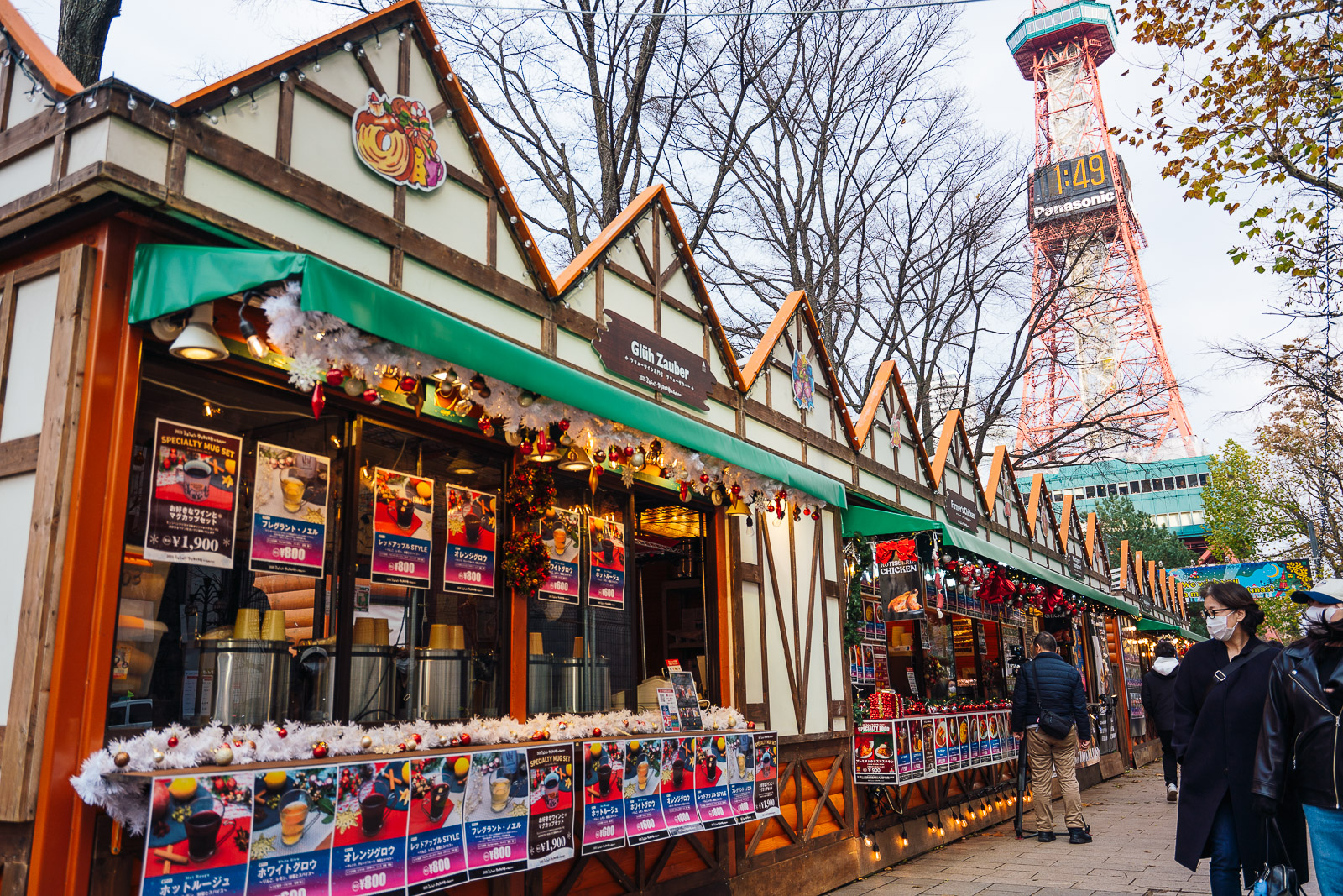 sapporo-christmas-market-2025-5 Sapporo Christmas Market festive stalls selling hot drinks and gifts with shoppers walking near the Sapporo TV Tower