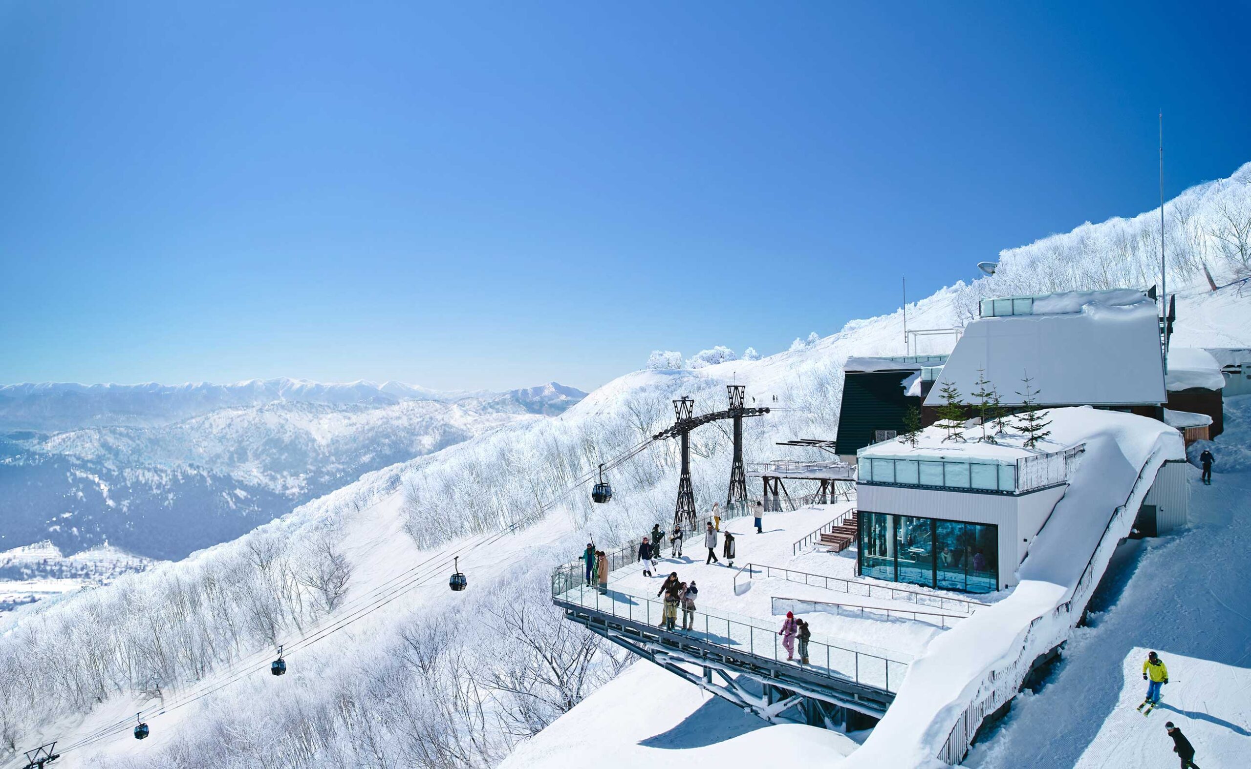An aerial view of Hirafu village covered in snow and a layer of fog
