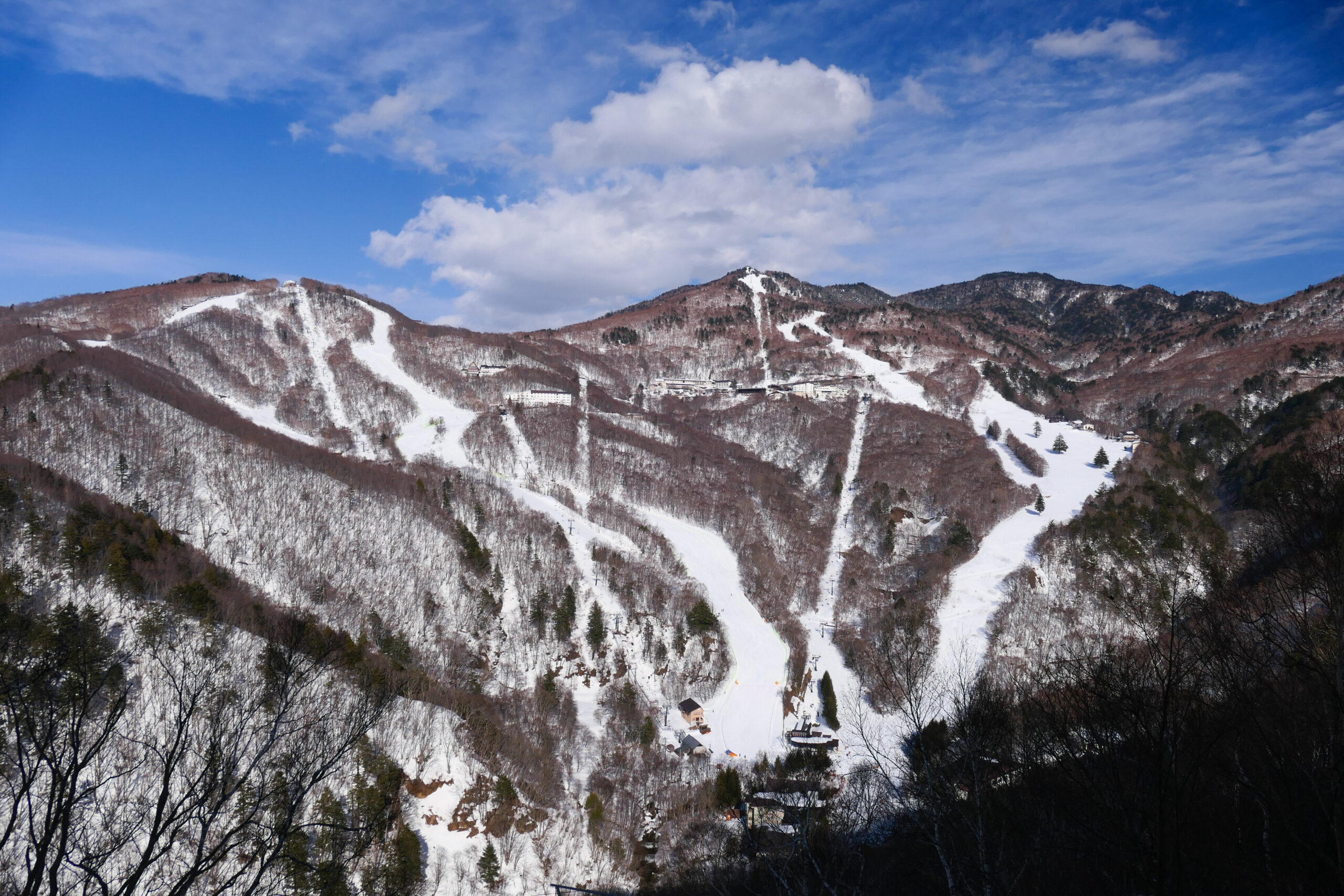 An aerial view of Hirafu village covered in snow and a layer of fog