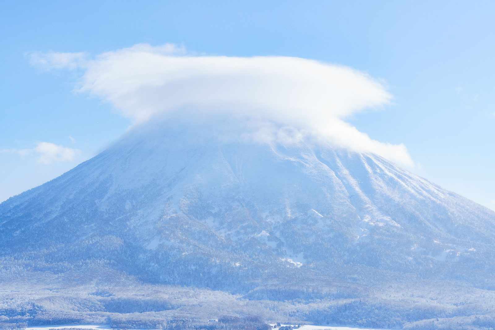 web-2425-landscape-mtyotei-006 An aerial view of Hirafu village covered in snow and a layer of fog